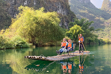Kelly Lynn Robichaud and her son on a bamboo raft at Yulong River, Yangshuo, Guilin